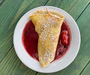 Vanilla cream filled crepe with plenty of plum-berry compote