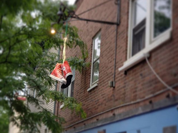 iconic sneaker's sign hanging on building